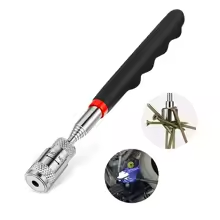 Powerful magnetic pick-up tool holding screws, pliers and a spanner